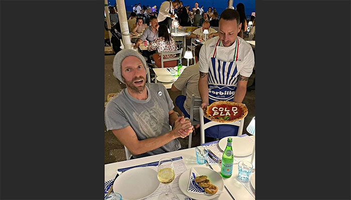 Chris Martin delighted with a Coldplay-themed pizza during his Naples trip.