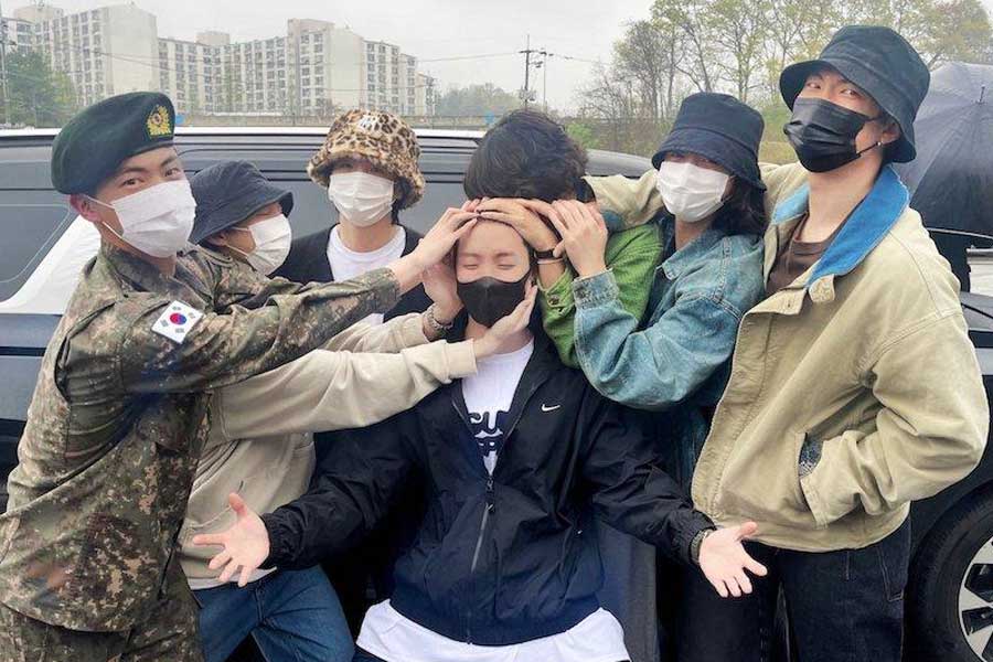 BTS members saying goodbye to J-hope